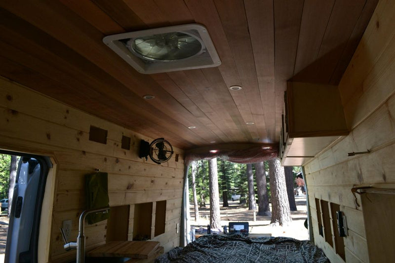  ready for a winter adventure.|This RV rental's wood-paneled interior features a cozy bed — photo 7