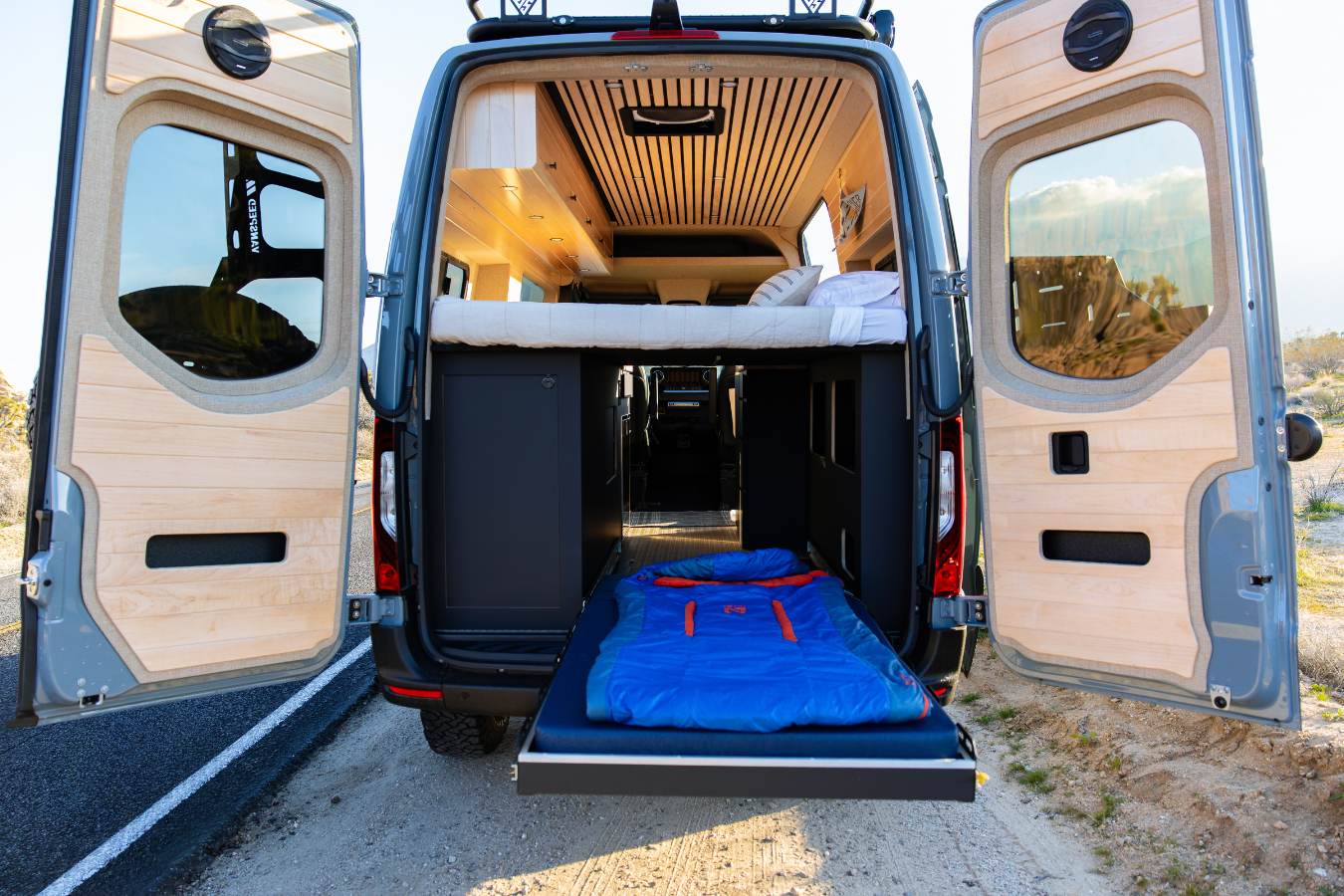  equipped with bright lights & gear for mountain adventures.|This RV rental interior features a kitchenette — photo 9