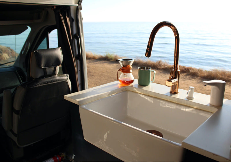  and a cozy brown leather lounge area. Van life ready.|White Ford Transit camper van — photo 4