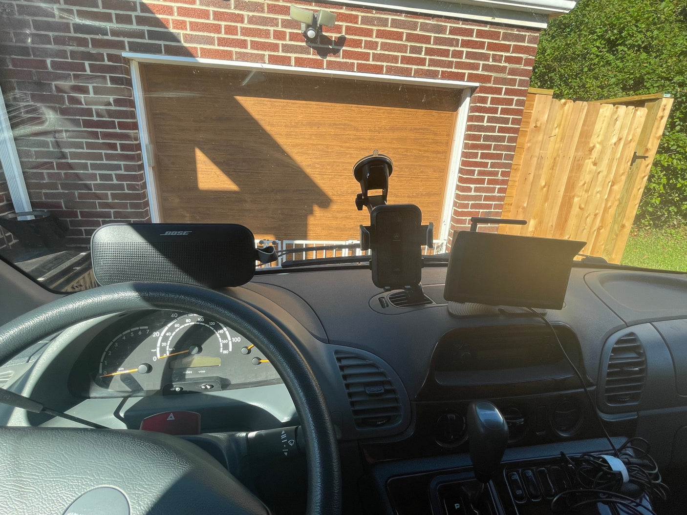 Dashboard view of an RV rental: Bose speaker, phone mount, and navigation screen, ready for the road ahead.