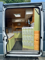 RV rental: Step inside this cozy camper van with wood accents, green cabinetry, and smart storage.