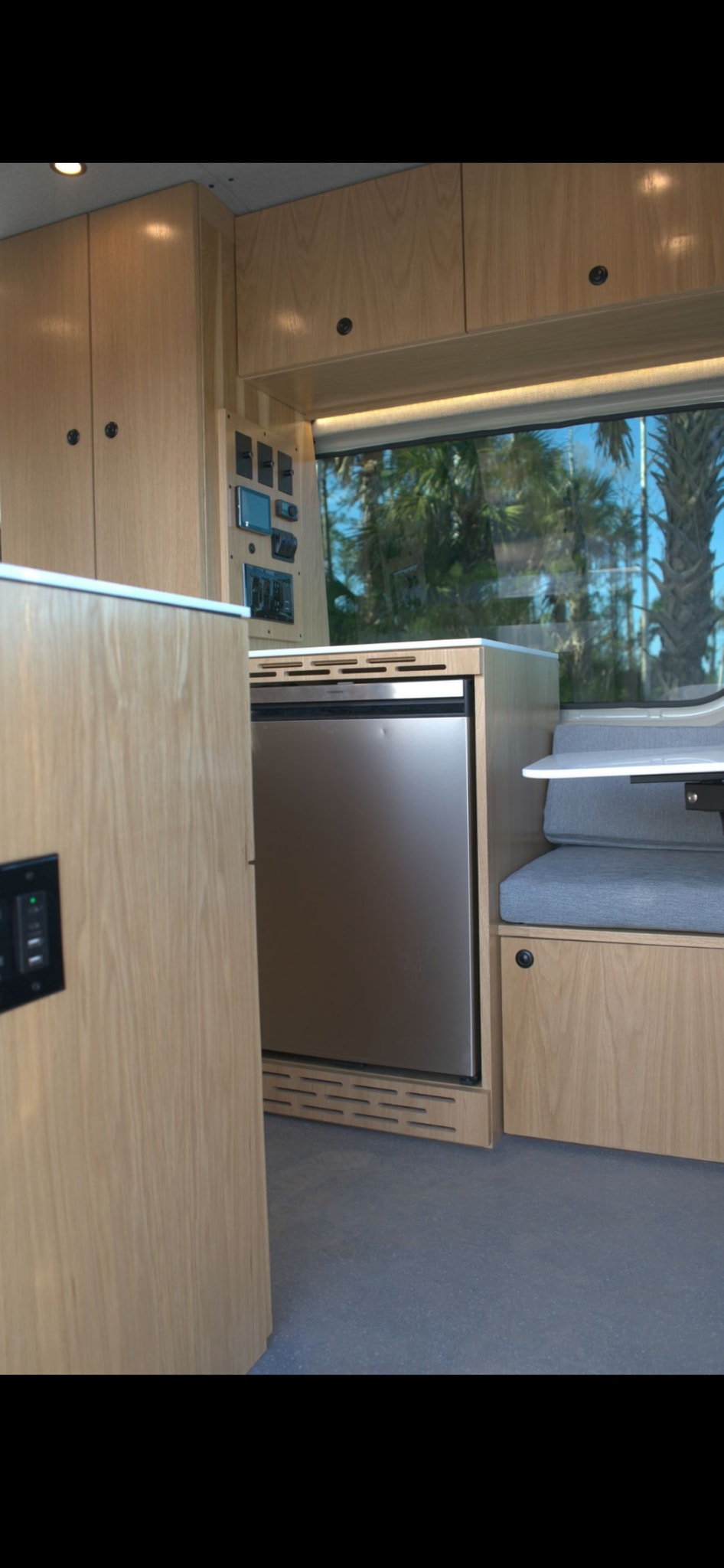  with an awning on top.|Modern rv rental interior: light wood cabinetry — photo 10