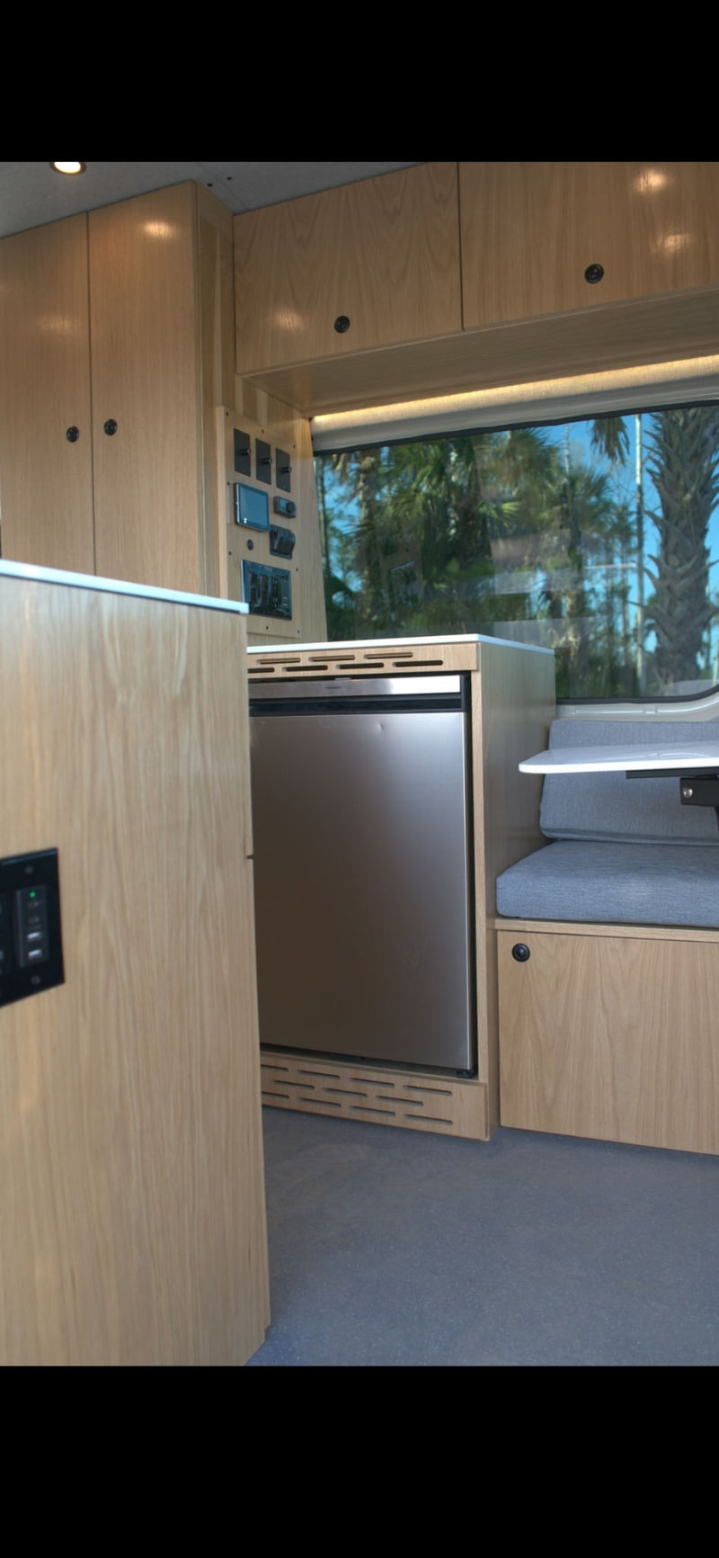  with an awning on top.|Modern rv rental interior: light wood cabinetry — photo 10
