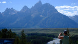 Grand Teton peaks, winding river, and a photographer. Perfect RV rental destination for scenic travel & outdoor adventures.