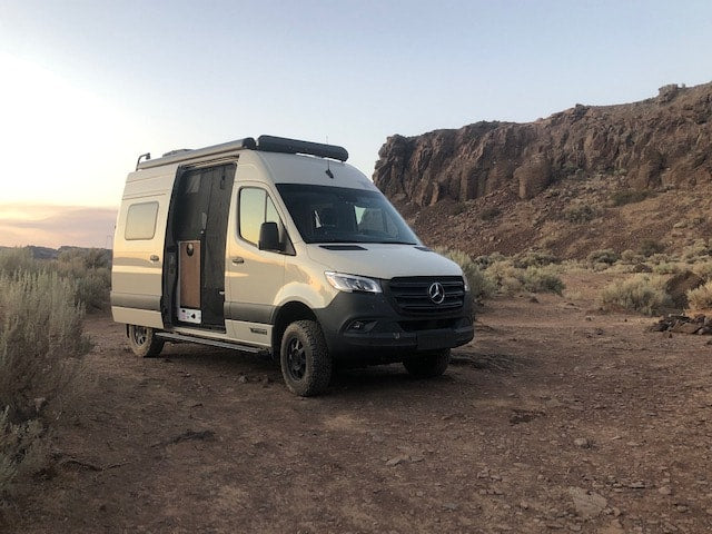  bathed in golden light.|A cream-colored Mercedes Sprinter rv rental — photo 2