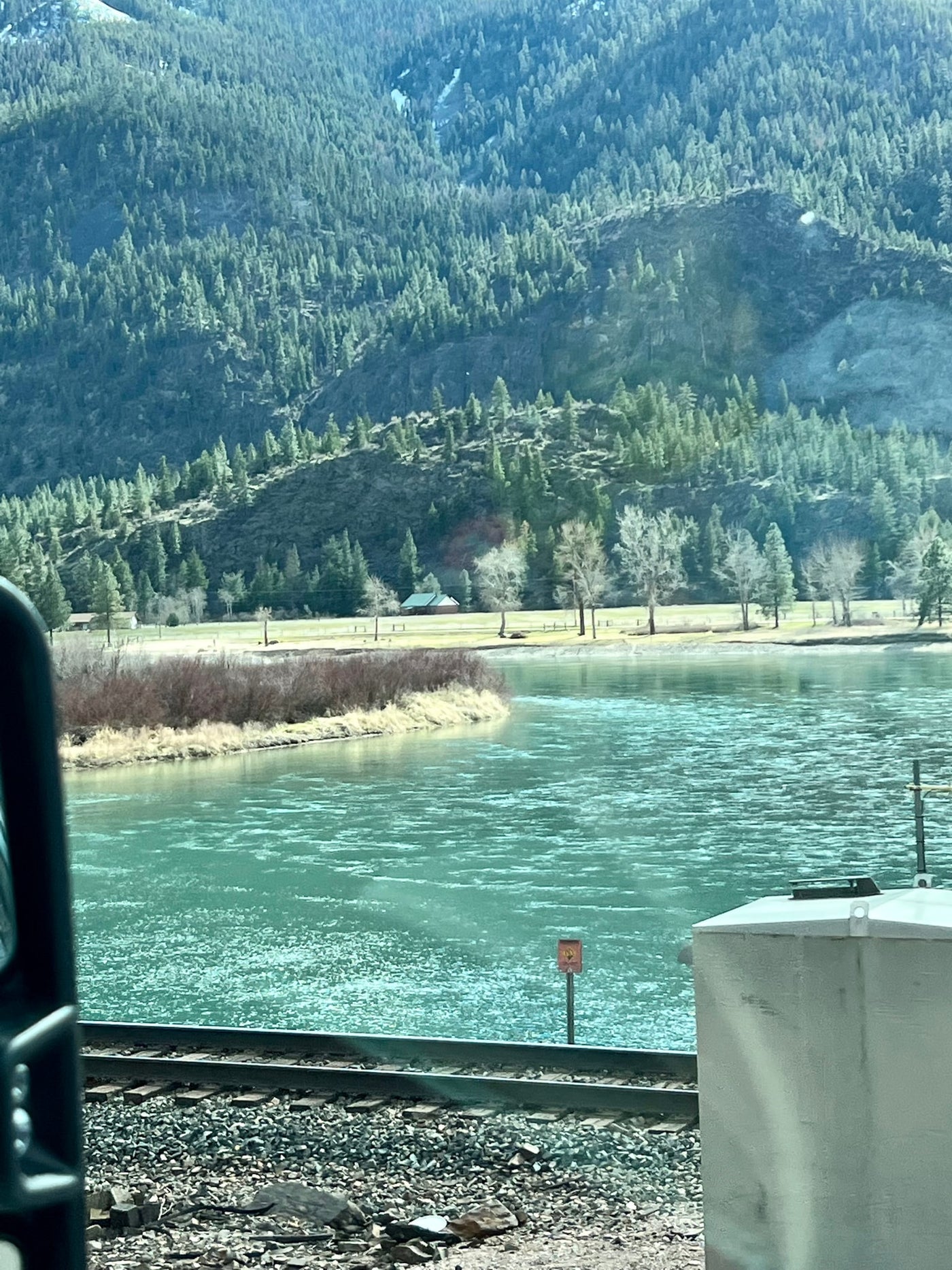 A vast landscape with a wide river, dense forested mountains, and a railroad line. Perfect for an RV rental adventure. — photo 19