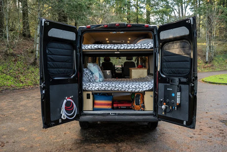 This RV rental camper van features a clever bunk bed interior with an outdoor shower and water heater.