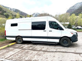White Sprinter RV rental van in a mountain setting, ideal for adventure & road trips.