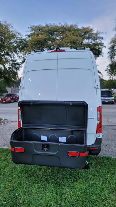 Rear view of an RV rental van with an open StowAway cargo box, offering ample external storage.