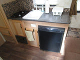 Explore this RV rental's galley: compact kitchen with stove, sink, Dometic fridge, and storage.