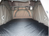 RV rental: Inside a spacious rooftop tent with a quilted sleeping pad, clear storage pockets, and arched window.