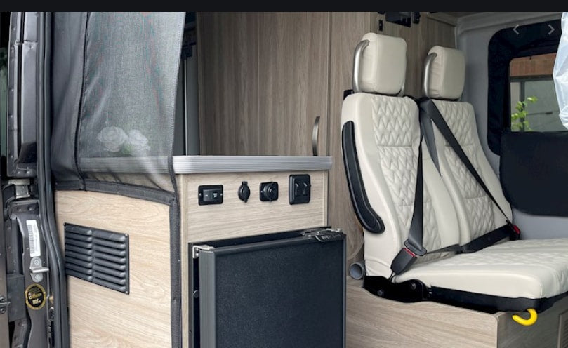  and plush passenger seating for your journey.|This RV rental features a compact kitchen: a two-burner stove — photo 3