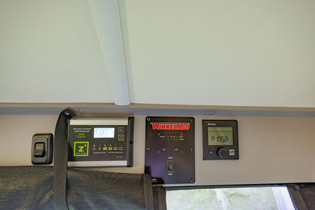 RV rental control panels: Zamp Solar charge, Winnebago water/pump, and Truma climate. Monitor your camper systems.