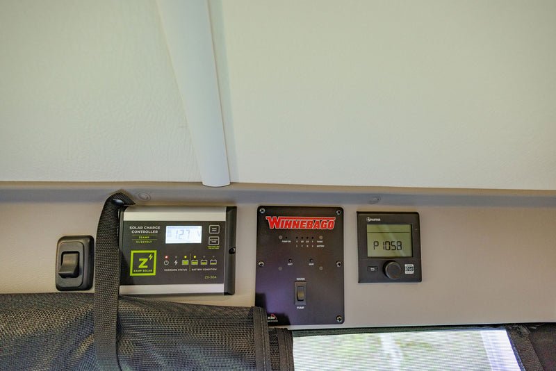  and a beautiful rear window view of a serene river. Perfect for mobile adventurers.|RV rental kitchen: compact stove — photo 13