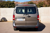 Rear view of a tan PeaceVans Modern Mercedes-Benz Metris camper van, an excellent option for rv rental adventures.