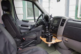 View of an RV rental's driver cockpit: seats, dashboard, custom wood cup holder tray, and infotainment.