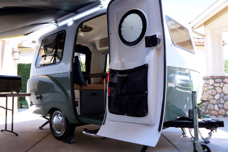 Step into this stylish two-tone travel trailer with open door & extended awning, an ideal RV rental for your next adventure.