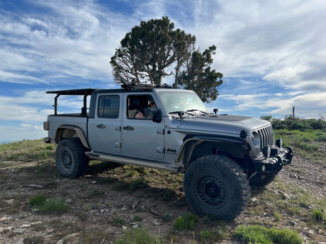 Grey Jeep Gladiator, equipped for rugged trails. Explore beyond traditional RV rentals with this off-road beast!