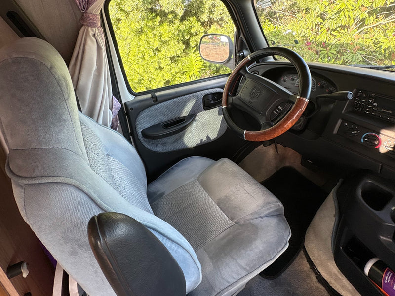  surrounded by palm trees.|Inside this cozy RV rental: a bed — photo 4