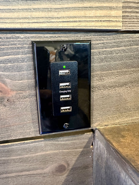 RV rental convenience: In-wall USB charging station with four ports, marked 'Charging Only' for devices.