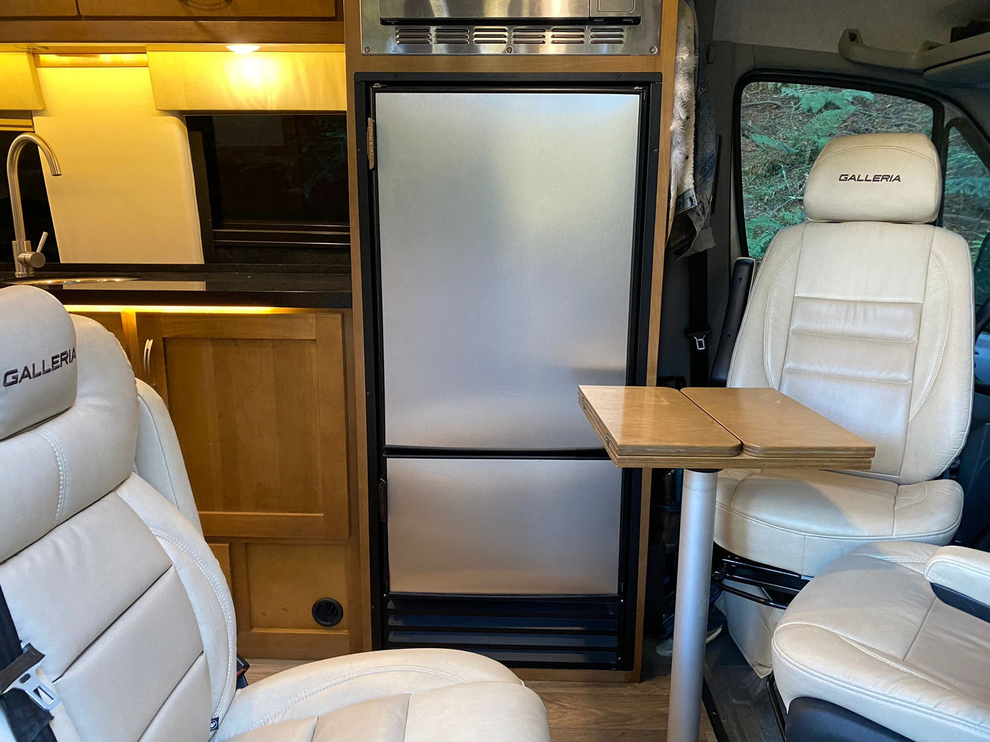  fridge) & leather seating.|Interior of an RV rental: features a sleek fridge — photo 2