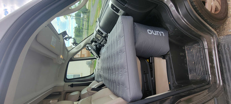 Inside a spacious van, a grey Luno air mattress transforms the area into a comfy bed for your rv rental trip. — photo 18