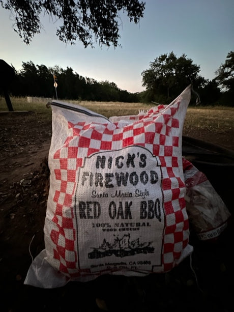 Bag of Nick's Red Oak BBQ firewood for your RV rental adventure, ready for Santa Maria style grilling.
