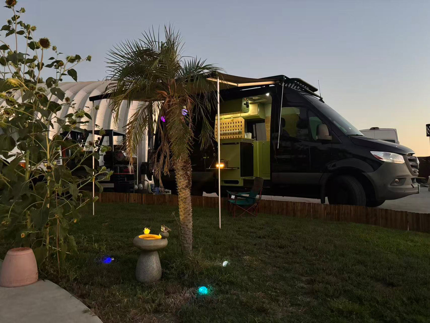 and chair in a cozy outdoor spot at sunset.|Experience adventure! This RV rental Sprinter van — photo 3