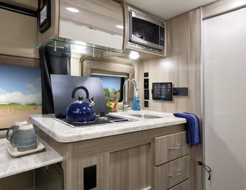  and control panels for travel comfort.|Side view of a grey Ram ProMaster RV rental — photo 4