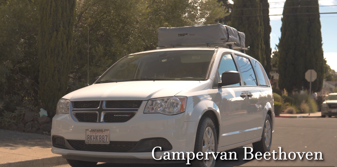 White Dodge minivan with a Thule rooftop tent, ideal for an RV rental adventure. "Campervan Beethoven" is labeled.