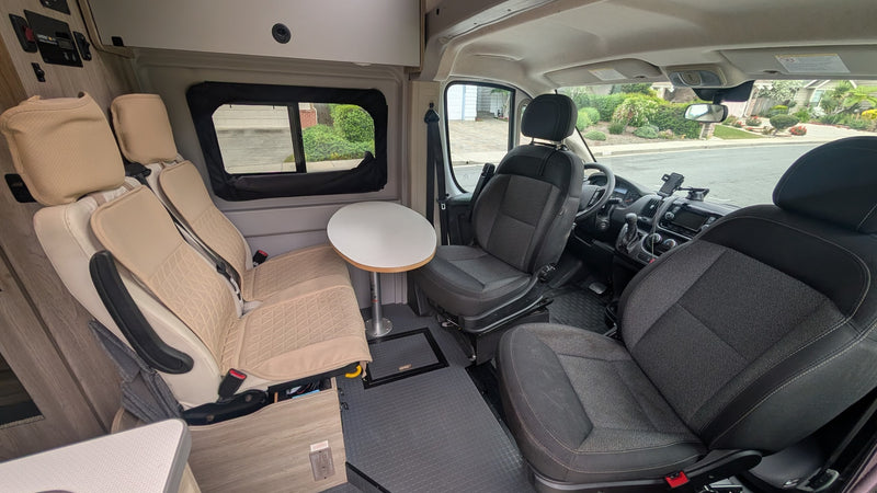 offering epic mountain and ocean views for your adventure.|White Winnebago Solis RV rental parked overlooking majestic mountains under a cloudy sky. Perfect for a scenic road trip.|An RV rental camper van parked on textured ground under a brilliant — photo 8