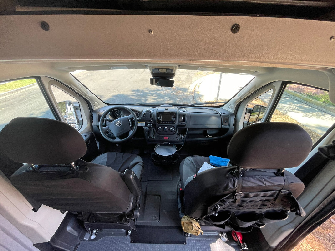 Spacious RV rental interior: Dashboard, steering wheel, and front seats visible for comfortable mobile living.
