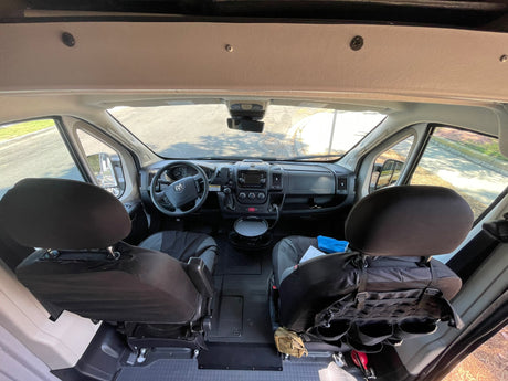 Spacious RV rental interior: Dashboard, steering wheel, and front seats visible for comfortable mobile living.
