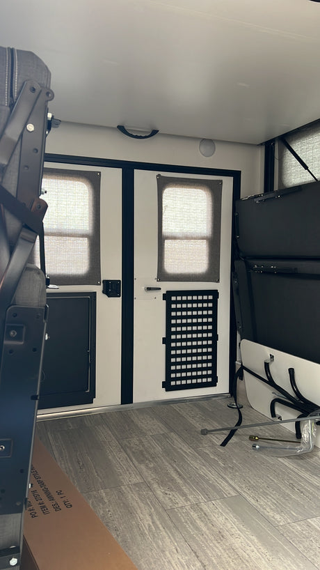 RV rental interior: versatile space with fold-down beds, rear windows, and adaptable cargo storage. Ready for adventure.
