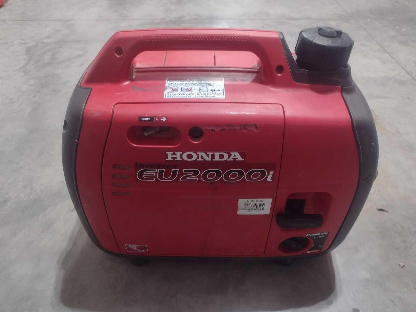 This portable red Honda EU2000i inverter generator provides reliable power, perfect for your RV rental adventures.