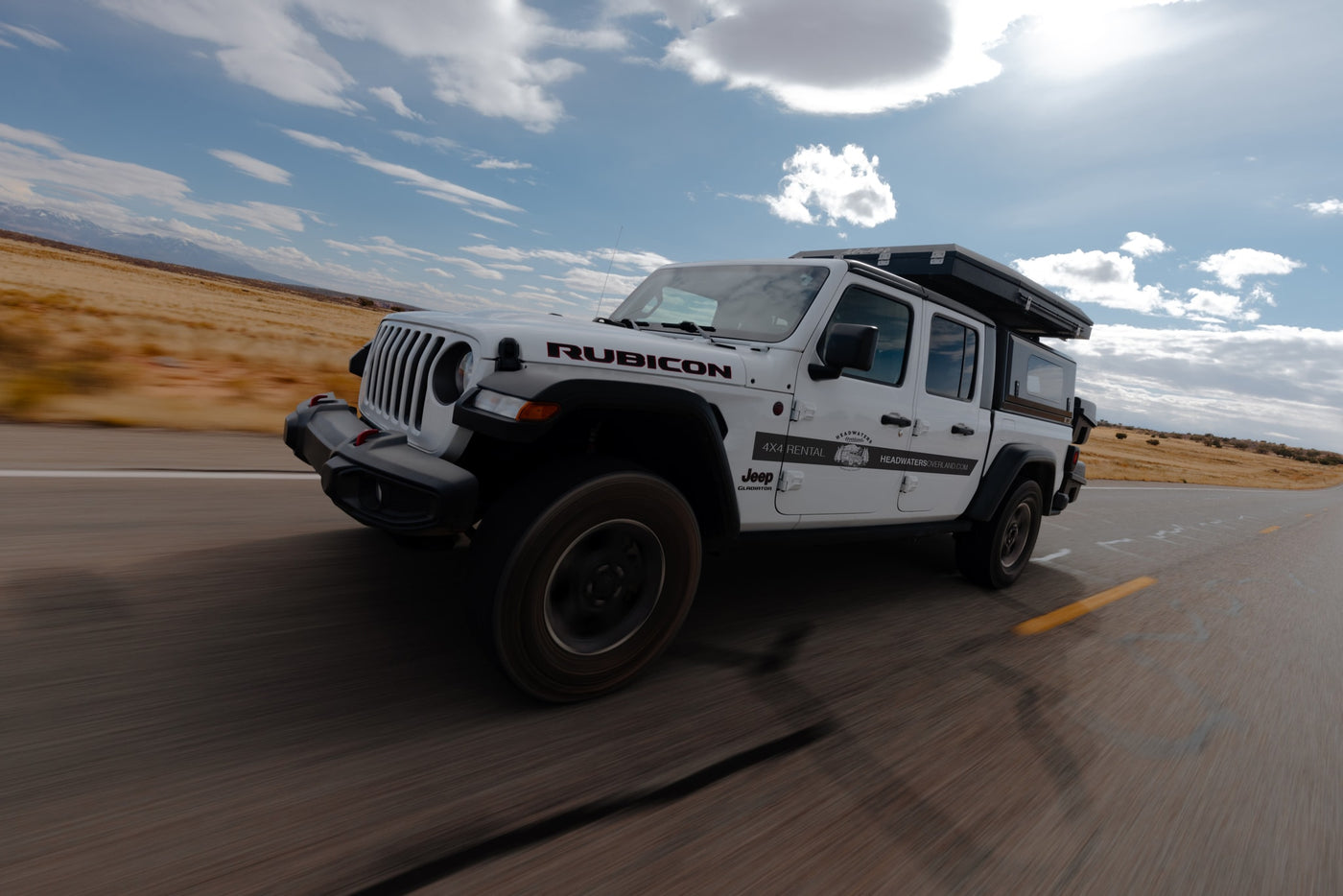White Jeep Gladiator RV rental with rooftop tent on an open road. Ideal for adventure travel & overlanding. — photo 7