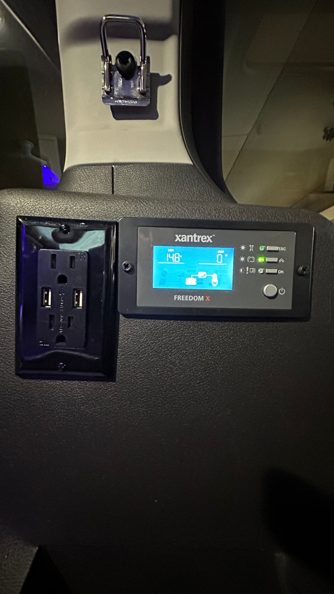 RV rental power hub: Xantrex Freedom X display shows 14.8V battery, integrated with AC and USB outlets for easy device charging. — photo 8