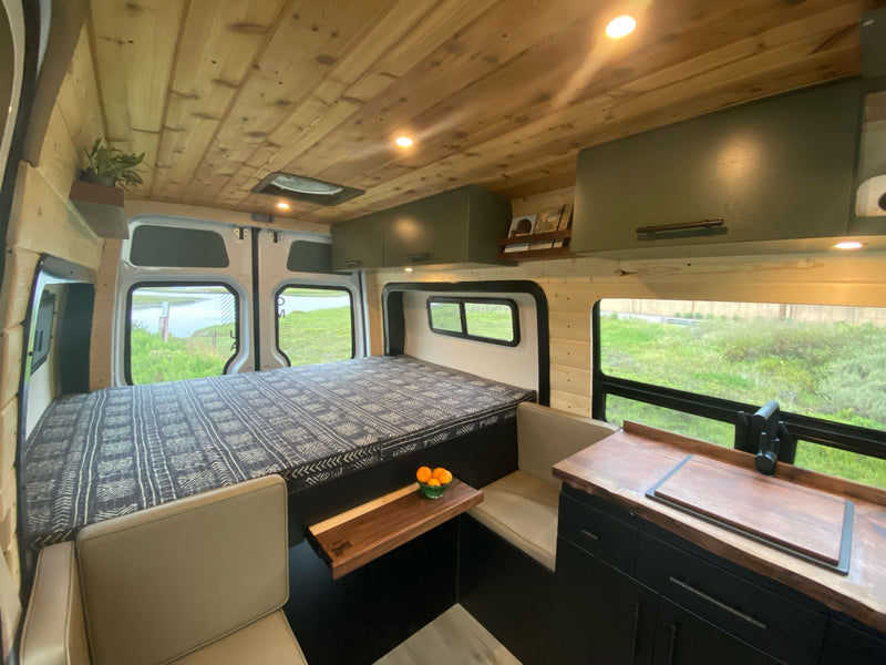  and inviting living space.|Modern RV rental kitchen featuring a live-edge wood counter — photo 6