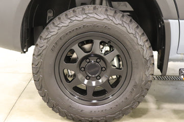 Close-up: rugged black off-road wheel & BFGoodrich tire. Ideal for your adventure RV rental exploration.