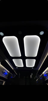 Step into comfort with this RV rental! Bright, modern ceiling lights and ambient blue accents illuminate a sleek, dark interior.