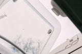 An open RV skylight provides natural light and a view of trees from inside an RV rental.