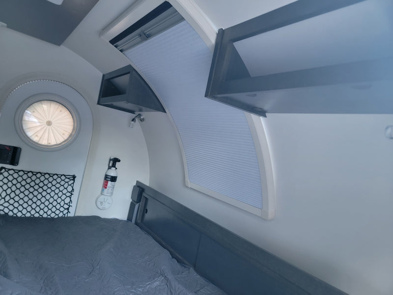  is ready for your next camping adventure.|Cozy RV rental interior with bed — photo 4