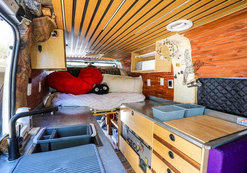 Discover a custom van conversion rv rental with a compact kitchen, cozy bed, and clever storage solutions. — photo 3