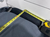 RV rental: Tape measure spanning a dark gray sleeping area, showing a length from approximately 58 to 76 inches. Practical RV space measurement.