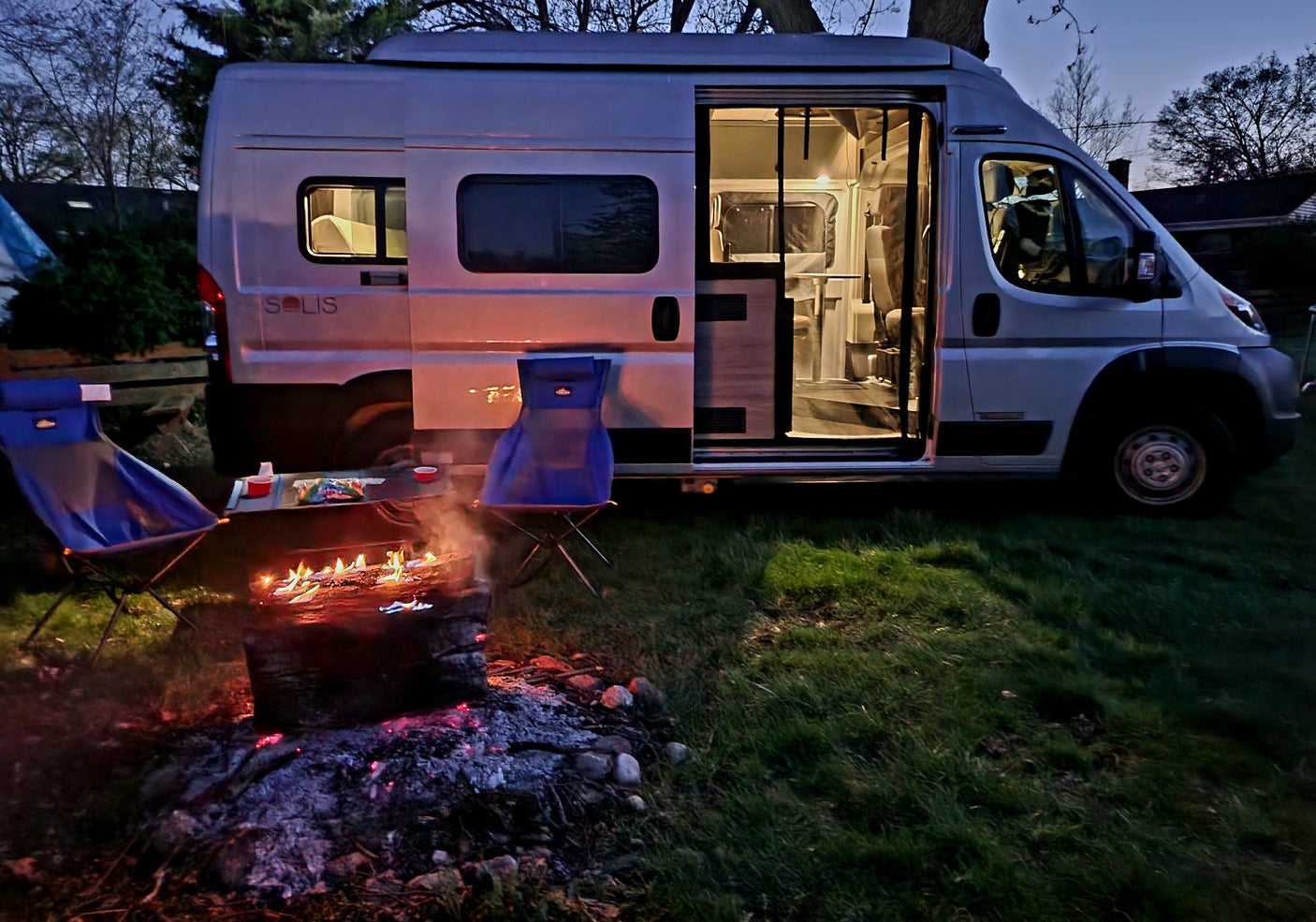 Cozy night by the campfire with an RV rental. Perfect outdoor escape under the stars.