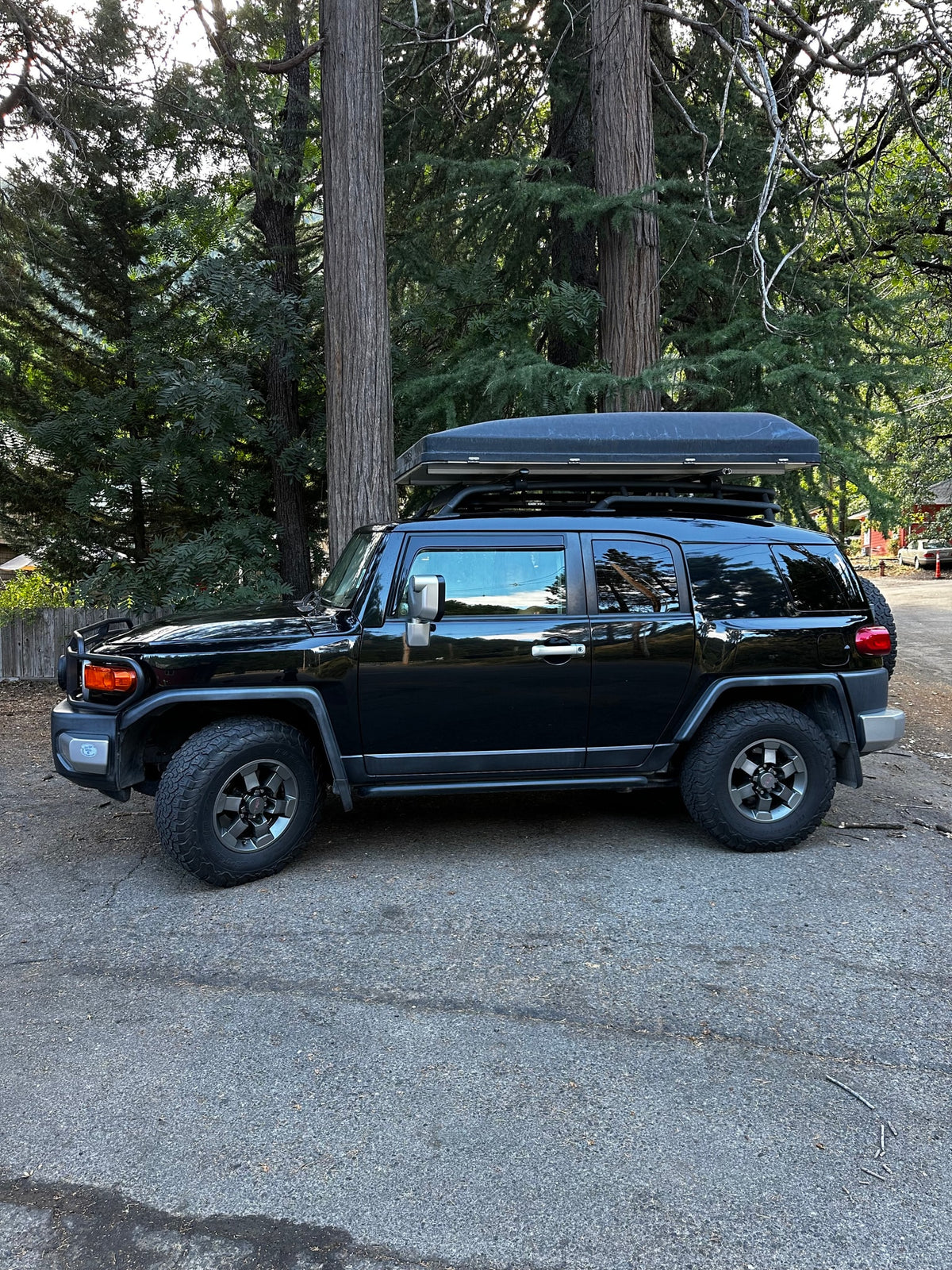 Black FJ Cruiser with rooftop tent, a versatile **RV rental** option for outdoor adventures and camping.