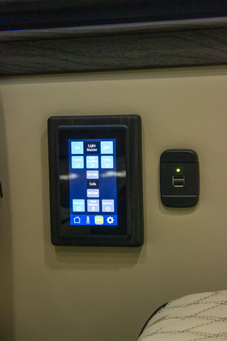 RV rental smart control panel for lights, sofa recline, internet, tank heaters, and inverter, with a USB port.