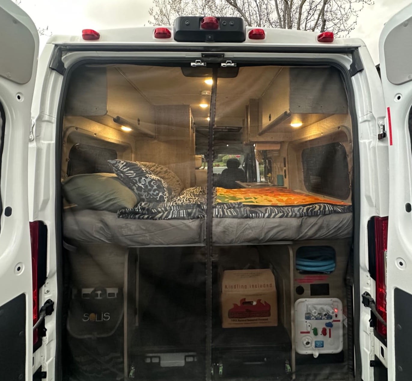  and front seats.|Compact RV rental kitchen with a two-burner gas stove — photo 15