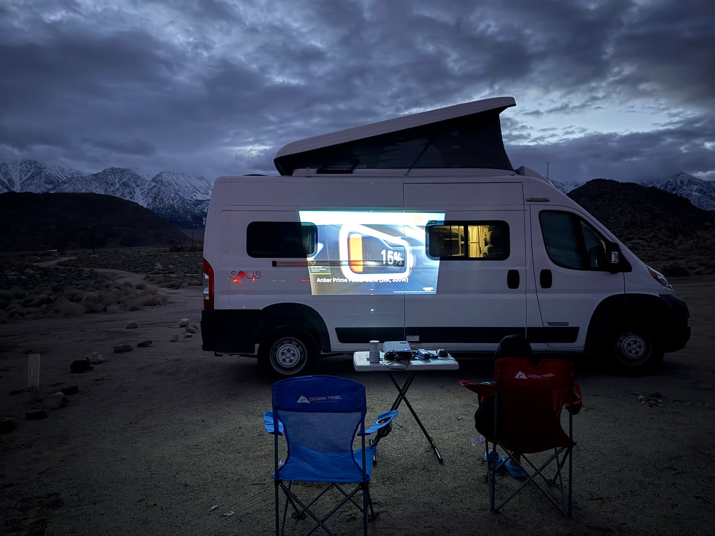  parked on a sunny concrete drive.|Cozy rv rental interior: kitchen with sink/stovetop — photo 4