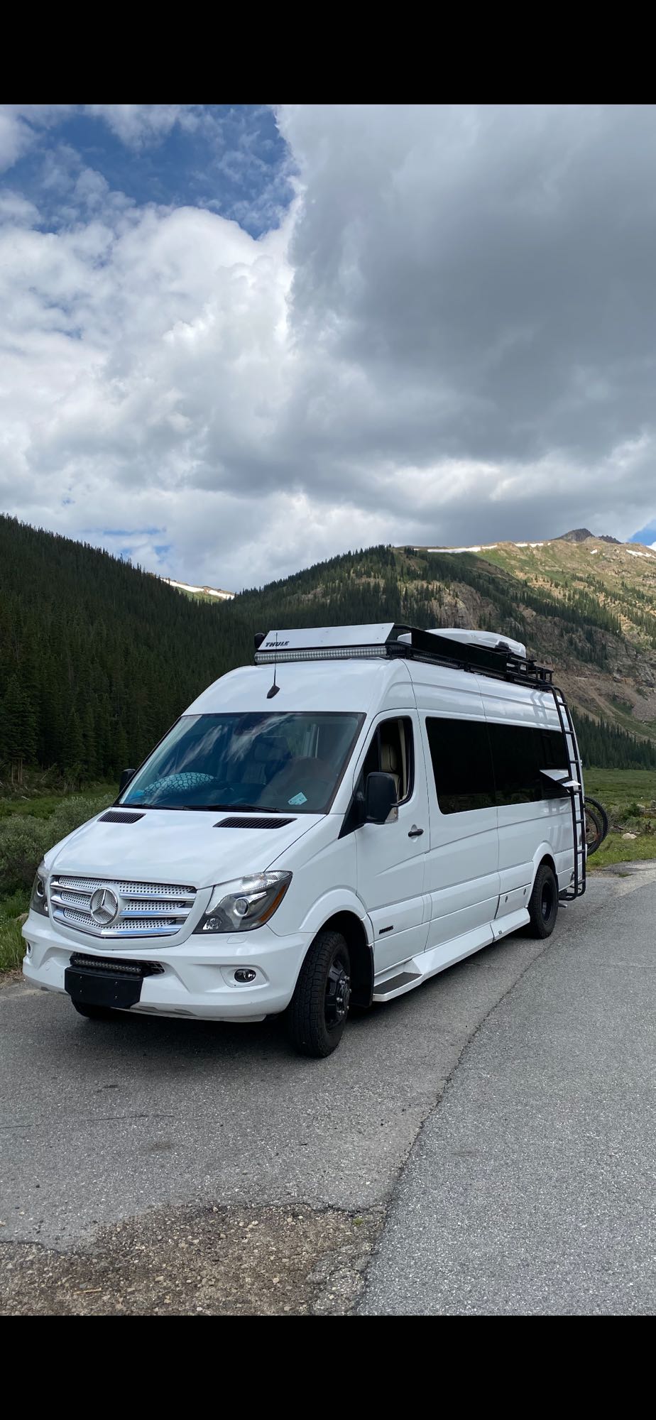 Adventure-ready white Mercedes-Benz Sprinter van, perfect for your next RV rental trip in the mountains.